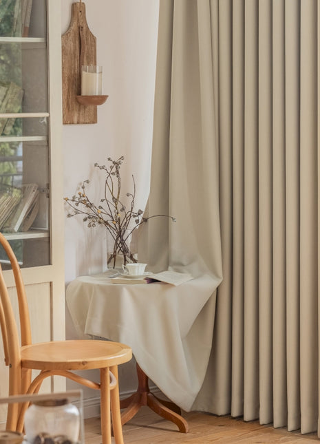 a room with a chair, table and a window