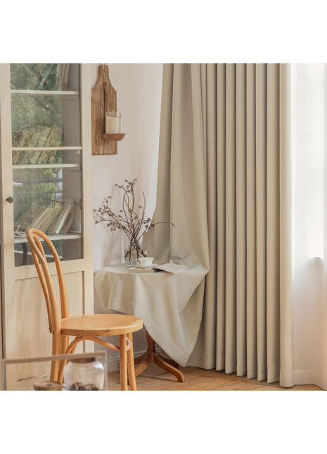 a room with a chair, table and a window