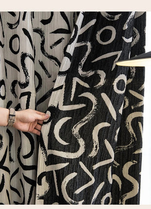 a woman is holding a black and white blanket