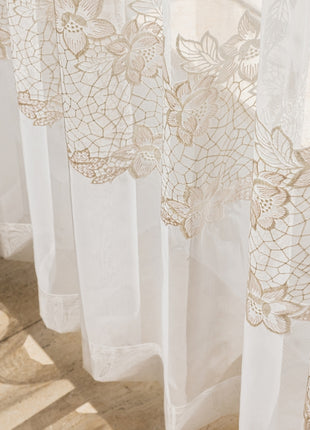 a close up of a window with a curtain