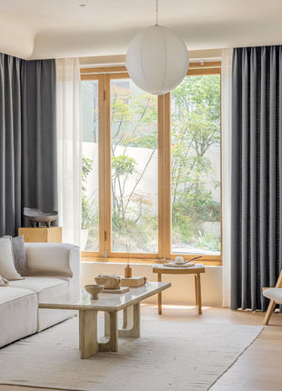 a living room filled with furniture and a large window