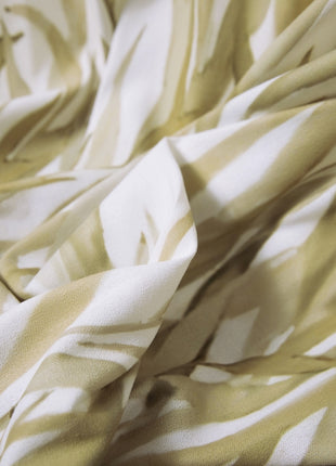 a close up of a yellow and white fabric
