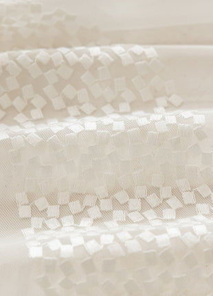 a close up of a white cloth with squares on it