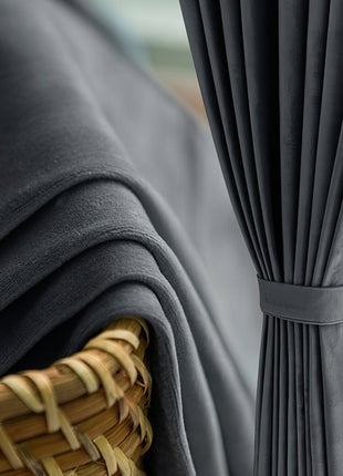 a close-up view of a gray fabric draped over a woven basket, with a gray curtain or drape hanging next to it.