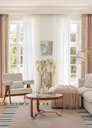 a living room filled with furniture and a large window
