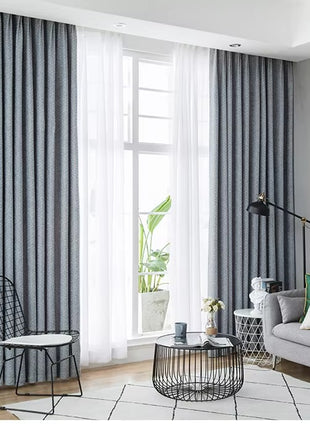 a living room filled with furniture and a large window